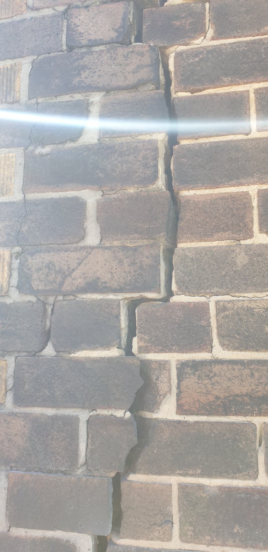 Close-up of cracked mortar joints between bricks