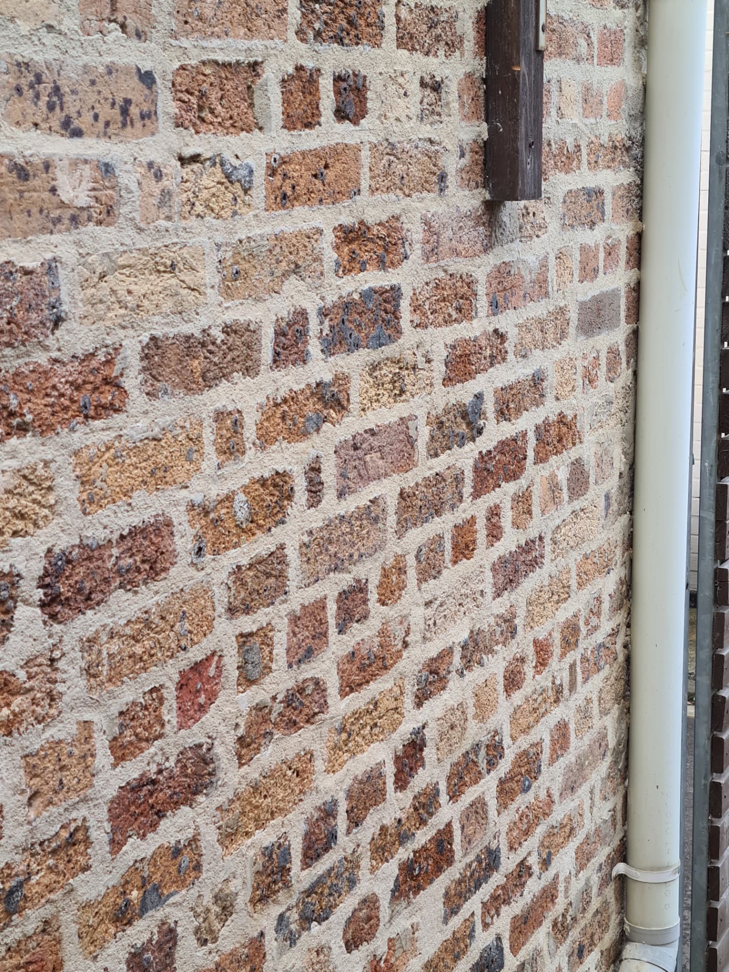 Crumbling powdery mortar in a brick joint